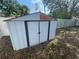 White metal storage shed with double doors in the backyard at 2226 Ridgemore Dr, Valrico, FL 33594