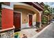 Exterior view of two condo building entrances with red doors and stone accents at 2245 Chianti Pl # 718, Palm Harbor, FL 34683