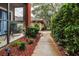 Well-manicured pathway with lush landscaping leading to condo building at 2245 Chianti Pl # 718, Palm Harbor, FL 34683