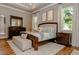 Elegant main bedroom with wood furniture and large windows at 2413 Baywood E Dr, Dunedin, FL 34698