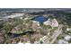 Aerial view of lakeside condo complex, baseball park and lots of surrounding trees and residences at 2679 Sabal Springs Cir # 102, Clearwater, FL 33761