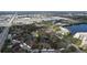 Aerial view of a lakeside condo complex with a community pool and easy access to nearby roads at 2679 Sabal Springs Cir # 102, Clearwater, FL 33761