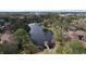 Aerial view of the community's pond surrounded by lush trees and well-maintained landscaping at 2679 Sabal Springs Cir # 102, Clearwater, FL 33761