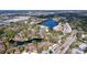 Aerial view of a community next to a lake featuring mature trees, multiple buildings and a neighborhood at 2679 Sabal Springs Cir # 102, Clearwater, FL 33761