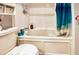 Bright bathroom with a bathtub, shower, and white tile at 2679 Sabal Springs Cir # 102, Clearwater, FL 33761