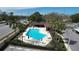 Aerial view of a community pool with lounge chairs, tables, and manicured landscaping at 2679 Sabal Springs Cir # 102, Clearwater, FL 33761