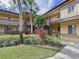 Exterior view of condo building with lush landscaping and covered walkways at 2679 Sabal Springs Cir # 102, Clearwater, FL 33761