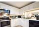 Efficient kitchen with stainless steel appliances and white cabinets at 2679 Sabal Springs Cir # 102, Clearwater, FL 33761