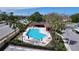 Aerial view of community pool area featuring palm trees, lounge chairs and a covered area at 2679 Sabal Springs Cir # 102, Clearwater, FL 33761