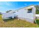 A bicycle and wheelbarrow are parked next to the mobile home at 27466 Us Highway 19 N # 54, Clearwater, FL 33761