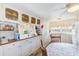 View of the kitchen with white cabinets, wooden table, and ample counter space at 27466 Us Highway 19 N # 54, Clearwater, FL 33761