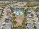 Overhead view of a community featuring a pool, tennis courts, clubhouse, and well-maintained landscaping at 2813 Punta Palma Ct, Holiday, FL 34691