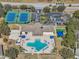 Aerial view of the community amenities including the pool, tennis courts, and playground at 2813 Punta Palma Ct, Holiday, FL 34691