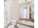 Bright bathroom featuring a tub/shower combo and vanity with generous counter space at 2813 Punta Palma Ct, Holiday, FL 34691