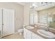 Bathroom featuring double sinks, a large mirror, and combination shower and tub at 2813 Punta Palma Ct, Holiday, FL 34691