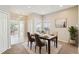 Cozy dining room with natural light, table set for four, and neutral decor at 2813 Punta Palma Ct, Holiday, FL 34691