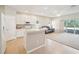 Modern kitchen with white cabinetry, stone countertops, and an open layout to the living area at 2813 Punta Palma Ct, Holiday, FL 34691