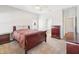 Bright main bedroom featuring a large bed, dresser, and ensuite bathroom at 2813 Punta Palma Ct, Holiday, FL 34691