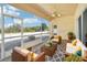 Relaxing screened patio featuring comfortable wicker furniture and a ceiling fan at 2813 Punta Palma Ct, Holiday, FL 34691