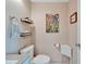 Clean bathroom with toilet and sink, decorative art at 302 Canton Ct # 63, Sun City Center, FL 33573