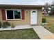 Condo exterior featuring a white door and red shutters at 302 Canton Ct # 63, Sun City Center, FL 33573