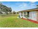 Backyard with a sunroom, overlooking a lush green lawn at 302 Canton Ct # 63, Sun City Center, FL 33573