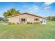 Tan single story home with red shutters, spacious grassy backyard at 302 Canton Ct # 63, Sun City Center, FL 33573