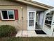 Back entrance with a drying rack and a golf cart in the background at 302 Canton Ct # 63, Sun City Center, FL 33573