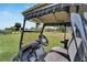 Tan golf cart with black interior and a view of the green at 302 Canton Ct # 63, Sun City Center, FL 33573