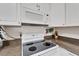 White kitchen with electric range and microwave at 302 Canton Ct # 63, Sun City Center, FL 33573