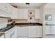 White kitchen with granite countertops and appliances at 302 Canton Ct # 63, Sun City Center, FL 33573