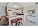 White kitchen with granite countertops and bar seating at 302 Canton Ct # 63, Sun City Center, FL 33573