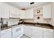 White kitchen with granite countertops and appliances at 302 Canton Ct # 63, Sun City Center, FL 33573