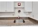 White kitchen with granite countertops and sink at 302 Canton Ct # 63, Sun City Center, FL 33573