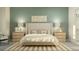 Serene bedroom with a king-size bed, two nightstands, and soft color palette at 31575 Cardinal Yard Dr, San Antonio, FL 33576