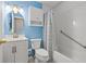 Clean bathroom with white subway tiles, a shower/tub combo and updated vanity at 36639 Jefferson Ave, Dade City, FL 33523