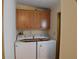 Practical laundry area with washer, dryer, and convenient overhead cabinets at 37642 Amigo Dr, Zephyrhills, FL 33541