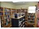 The community library features floor to ceiling wood shelves holding many books, and a table at 37642 Amigo Dr, Zephyrhills, FL 33541