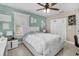 Bright bedroom with window, ceiling fan, and ample closet space at 3906 Bloomingdale Ave, Valrico, FL 33596