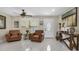 Spacious living room with leather seating, large windows, and tile floors at 3906 Bloomingdale Ave, Valrico, FL 33596