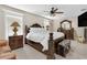 Main bedroom with king-size bed and dark wood furniture at 3906 Bloomingdale Ave, Valrico, FL 33596