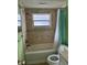 Updated bathroom with a tub and green walls at 4221 Touchton Pl # A, New Port Richey, FL 34652