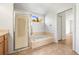 Well-lit bathroom featuring a bathtub with shower and a window offering natural light at 4251 Whittner Dr, Land O Lakes, FL 34639