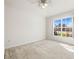 Spacious bedroom featuring neutral carpet, a ceiling fan and a window with a view of outside at 4251 Whittner Dr, Land O Lakes, FL 34639