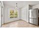 Bright dining area with sliding door access to the patio, stainless refrigerator, and closet at 4251 Whittner Dr, Land O Lakes, FL 34639