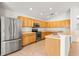 Well-lit kitchen featuring stainless steel appliances, lots of wood cabinetry and a breakfast bar at 4251 Whittner Dr, Land O Lakes, FL 34639