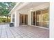 Back patio with tile flooring and sliding glass doors leading into the interior of the home at 4251 Whittner Dr, Land O Lakes, FL 34639