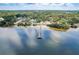 Captivating aerial view of a community pier over the bay and surrounded by trees and calm waters at 523 Georgia Ave, Crystal Beach, FL 34681