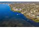 Panoramic aerial view of a waterfront property with a private dock, surrounded by lush vegetation at 523 Georgia Ave, Crystal Beach, FL 34681