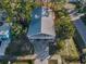 Aerial view of a two-story home with mature trees and a well-maintained yard at 523 Georgia Ave, Crystal Beach, FL 34681